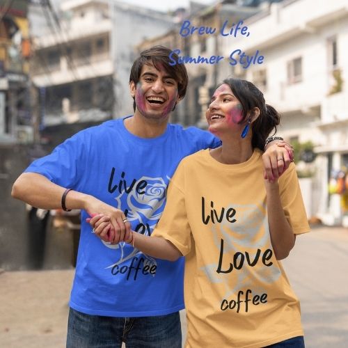 A joyful couple wearing matching “Live, Love, Coffee” tee shirts from Coo Coo’s Coffee share a laugh in a lively city courtyard — capturing the spirit of connection, fun, and everyday coffee moments with friends.